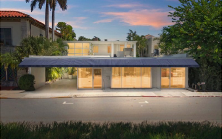 Modern house with large windows at sunset