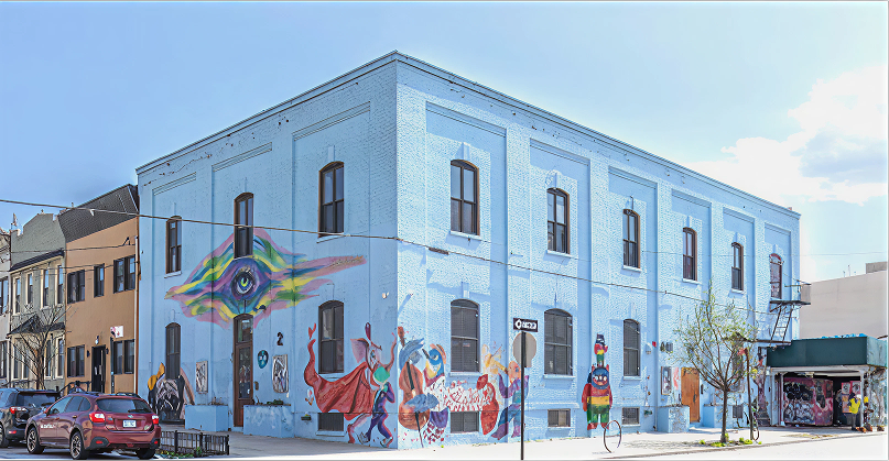 Urban mural on large blue building.