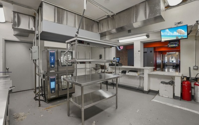 Commercial kitchen with stainless steel tables