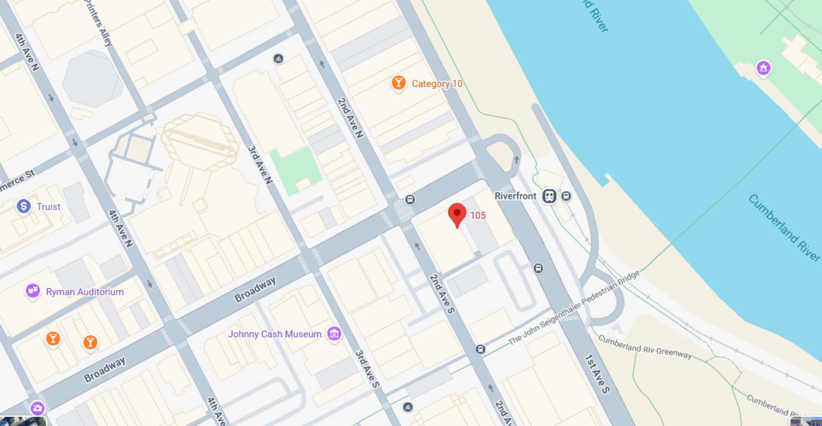 Map with red location pin by riverfront